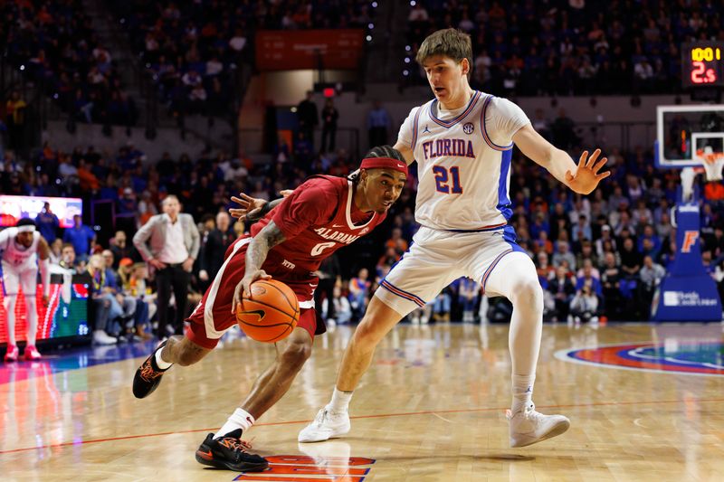 Feb 1, 2026; Gainesville, Florida, USA; Alabama Crimson Tide guard Labaron Philon (0) drives to the basket past Florida Gators forward Alex Condon (21) during the first half at Exactech Arena at the Stephen C. O'Connell Center. Mandatory Credit: Matt Pendleton-Imagn Images