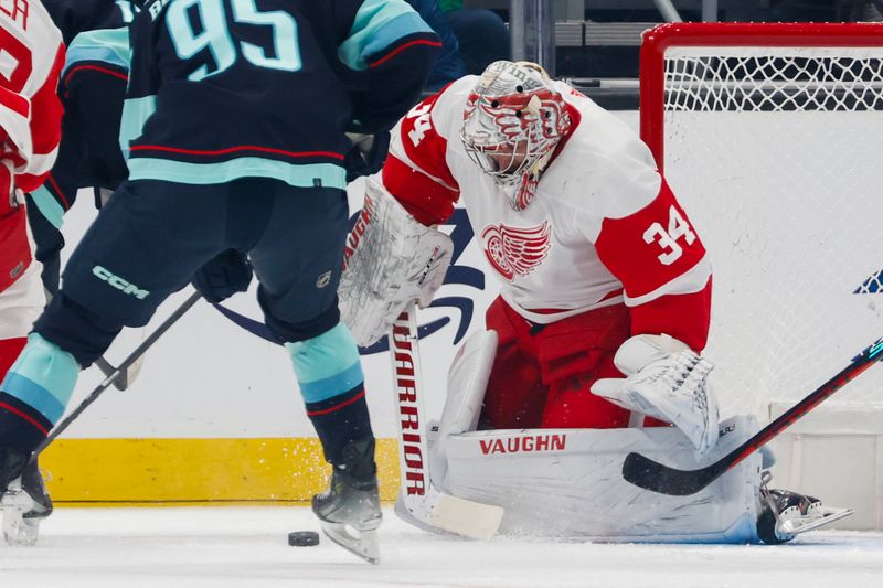 Feb 19, 2024; Seattle, Washington, USA; Detroit Red Wings goaltender Alex Lyon (34) blocks a shot against the Seattle Kraken during the first period at Climate Pledge Arena. Mandatory Credit: Joe Nicholson-USA TODAY Sports