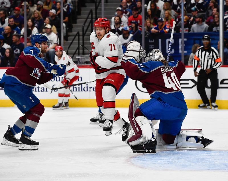 Oct 21, 2023; Denver, Colorado, USA; Carolina Hurricanes right wing Jesper Fast (71) grimaces as the puck sails past as Colorado Avalanche goaltender Alexandar Georgiev (40) tries to make the save in the first period at Ball Arena. Mandatory Credit: John Leyba-USA TODAY Sports