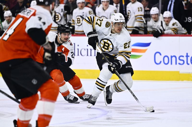 Jan 27, 2024; Philadelphia, Pennsylvania, USA; Boston Bruins defenseman Hampus Lindholm (27) controls the puck against the Philadelphia Flyers in the first period at Wells Fargo Center. Mandatory Credit: Kyle Ross-USA TODAY Sports