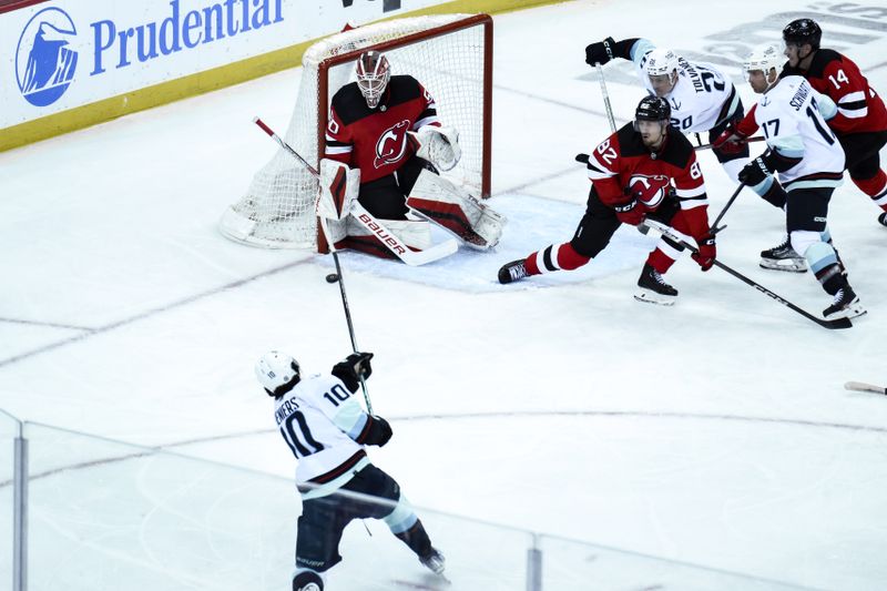 Feb 12, 2024; Newark, New Jersey, USA; New Jersey Devils goaltender Nico Daws (50) makes a save on a shot by Seattle Kraken center Matty Beniers (10) during the third period at Prudential Center. Mandatory Credit: John Jones-USA TODAY Sports