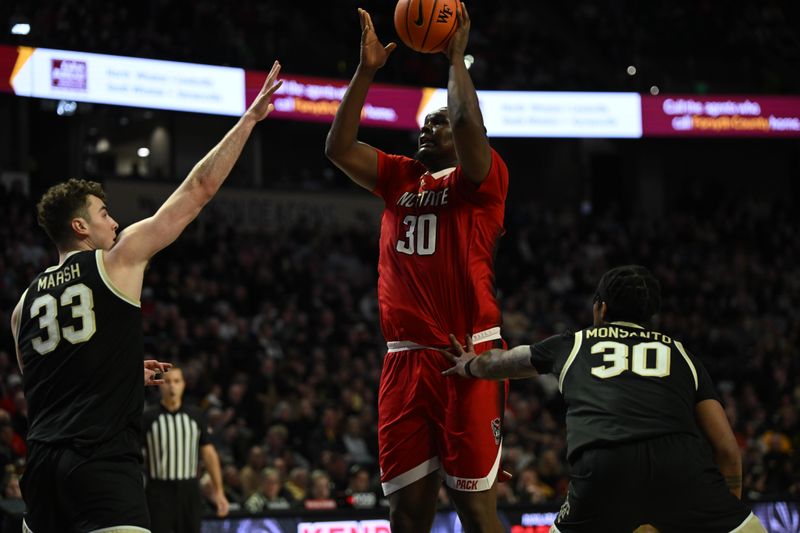 Jan 28, 2023; Winston-Salem, North Carolina, USA;   North Carolina State Wolfpack forward D.J. Burns Jr. (30) shoots over Wake Forest Demon Deacons forward Matthew Marsh (33) during the second half at Lawrence Joel Veterans Memorial Coliseum. Mandatory Credit: William Howard-USA TODAY Sports