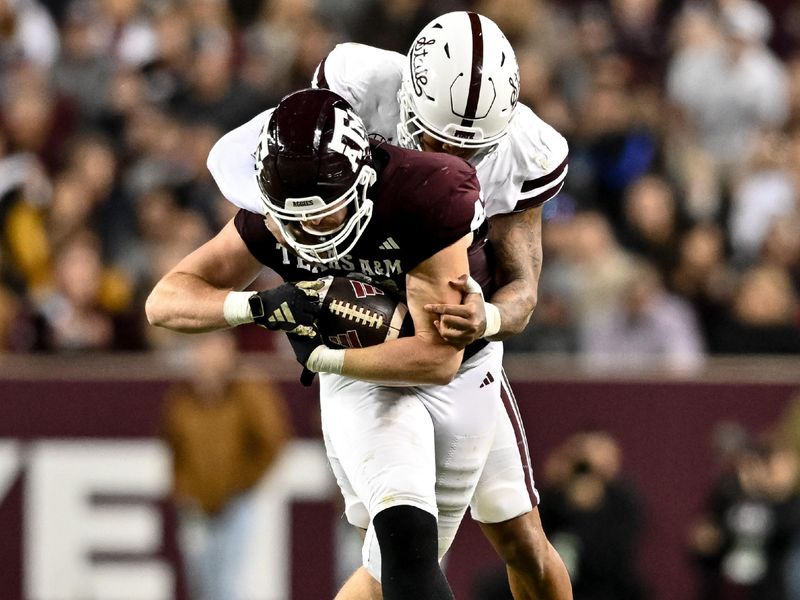 Nov 11, 2023; College Station, Texas, USA; Mississippi State Bulldogs linebacker Nathaniel Watson (14) tackles Texas A&M Aggies tight end Max Wright (42) during the second half at Kyle Field. Mandatory Credit: Maria Lysaker-USA TODAY Sports