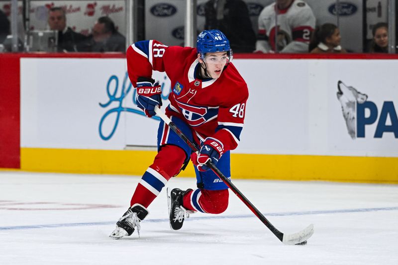 Oct 12, 2024; Montreal, Quebec, CAN; Montreal Canadiens defenseman Lane Hutson (48) plays the puck against the Ottawa Senators during the first period at Bell Centre. Mandatory Credit: David Kirouac-Imagn Images