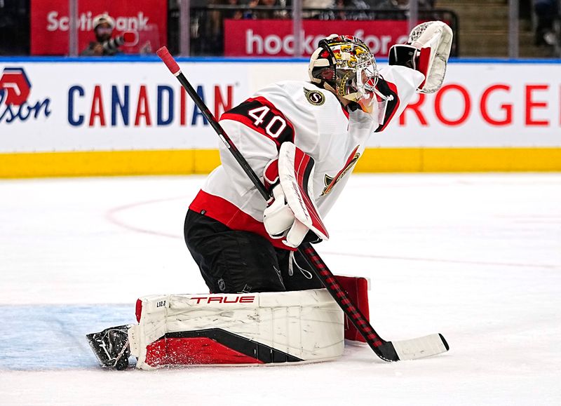 Sep 24, 2022; Toronto, Ontario, CAN; Ottawa Senators goaltender Mads Sogaard (40) reaches for a puck against the Toronto Maple Leafs during the second period at Scotiabank Arena. Mandatory Credit: John E. Sokolowski-USA TODAY Sports