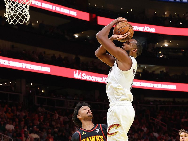 ATLANTA, GEORGIA - NOVEMBER 29:  Evan Mobley #4 of the Cleveland Cavaliers loses the ball as he draws a foul from Kobe Bufkin #4 of the Atlanta Hawks during the third quarter of the Emirates NBA Cup game at State Farm Arena on November 29, 2024 in Atlanta, Georgia.  NOTE TO USER: User expressly acknowledges and agrees that, by downloading and/or using this photograph, user is consenting to the terms and conditions of the Getty Images License Agreement.  (Photo by Kevin C. Cox/Getty Images)