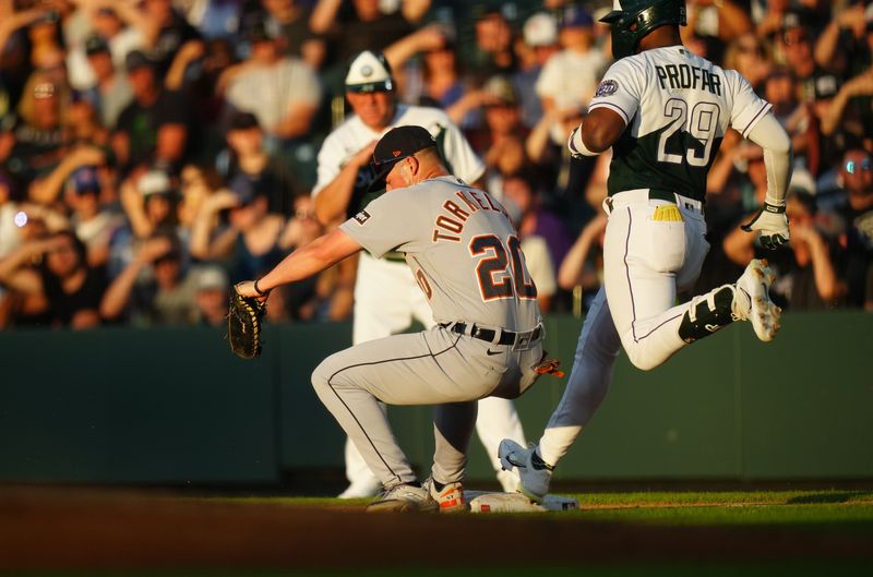 Jul 1, 2023; Denver, Colorado, USA; Detroit Tigers first baseman Spencer Torkelson (20) fields the ball on Colorado Rockies left fielder Jurickson Profar (29) in the third inning at Coors Field. Mandatory Credit: Ron Chenoy-USA TODAY Sports