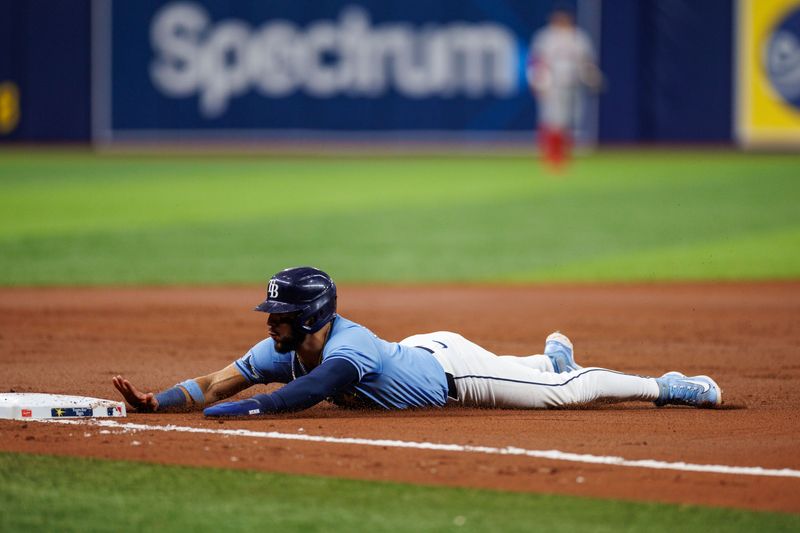 May 22, 2024; St. Petersburg, Florida, USA;  Tampa Bay Rays shortstop Jose Caballero (7) slides into third base against the Boston Red Sox in the second inning at Tropicana Field. Mandatory Credit: Nathan Ray Seebeck-USA TODAY Sports