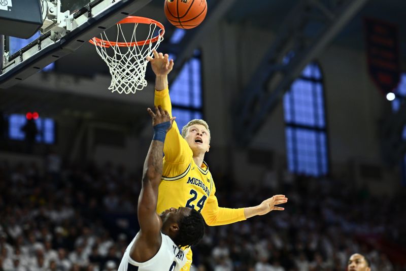 Jan 7, 2024; Philadelphia, Pennsylvania, USA; Michigan Wolverines forward Youssef Khayat (24) blocks a shot from Penn State Nittany Lions guard Kanye Clary (0) in the first half at The Palestra. Mandatory Credit: Kyle Ross-USA TODAY Sports