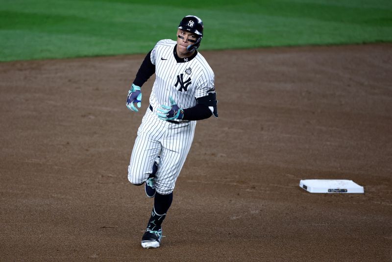 Oct 30, 2024; New York, New York, USA; New York Yankees outfielder Aaron Judge (99) rounds the bases after hitting a two-run home during the first inning against the Los Angeles Dodgers in game five of the 2024 MLB World Series at Yankee Stadium. Mandatory Credit: Wendell Cruz-Imagn Images