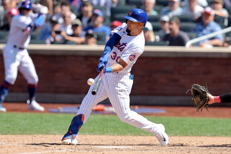 Aug 27, 2023; New York City, New York, USA; New York Mets left fielder Rafael Ortega (30) hits a walkoff single against the Los Angeles Angels during the ninth inning at Citi Field. Mandatory Credit: Brad Penner-USA TODAY Sports