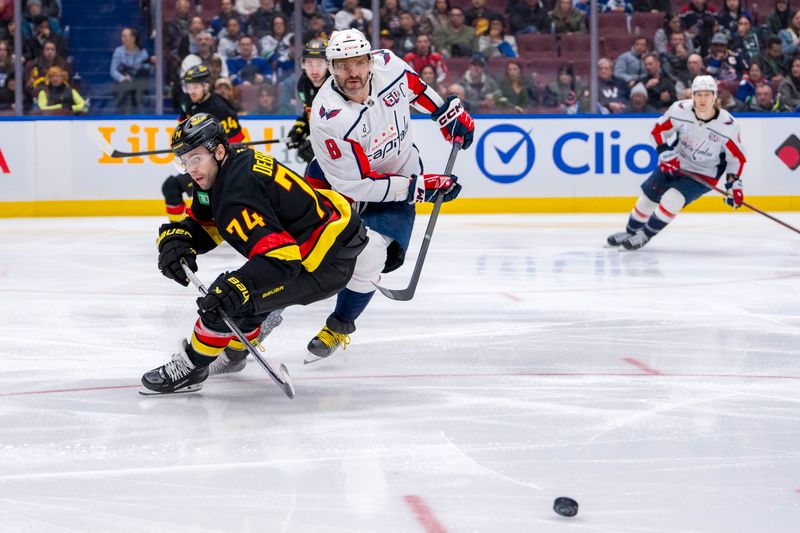 Jan 25, 2025; Vancouver, British Columbia, CAN;  Vancouver Canucks forward Jake DeBrusk (74) and Washington Capitals forward Alex Ovechkin (8) watch the loose puck in the third period at Rogers Arena. Mandatory Credit: Bob Frid-Imagn Images