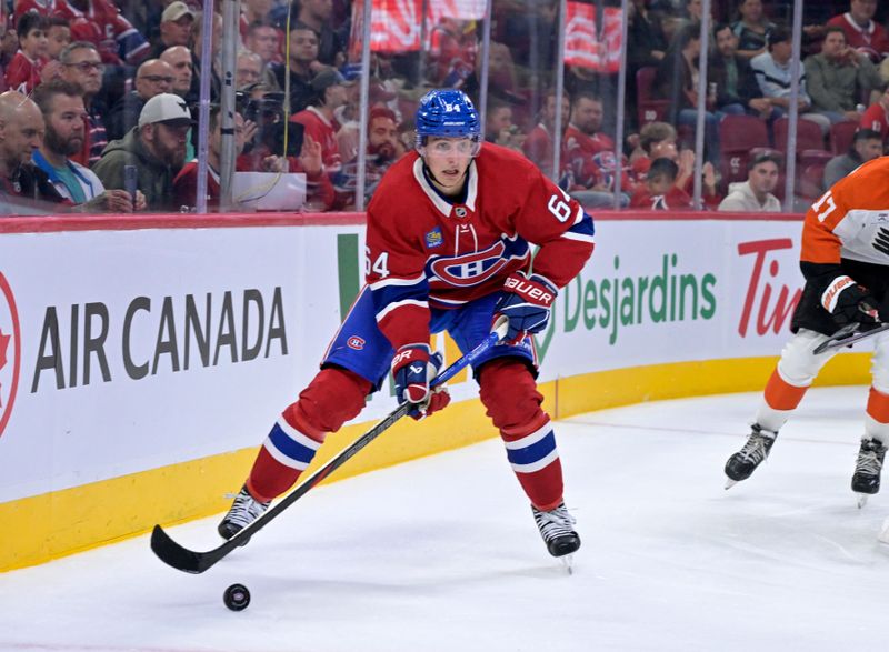 Sep 23, 2025; Montreal, Quebec, CAN; Montreal Canadiens defenseman David Reinbacher (64) plays the puck during the second period against the Philadelphia Flyers at the Bell Centre. Mandatory Credit: Eric Bolte-Imagn Images
