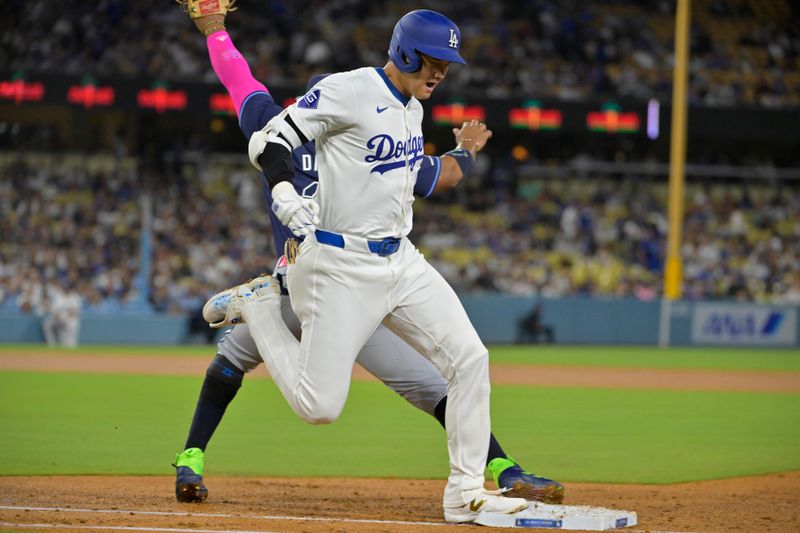 Aug 23, 2024; Los Angeles, California, USA;  Los Angeles Dodgers designated hitter Shohei Ohtani (17) beats the throw to Tampa Bay Rays first baseman Yandy Diaz (2) for a single in the fourth inning at Dodger Stadium. Mandatory Credit: Jayne Kamin-Oncea-USA TODAY Sports