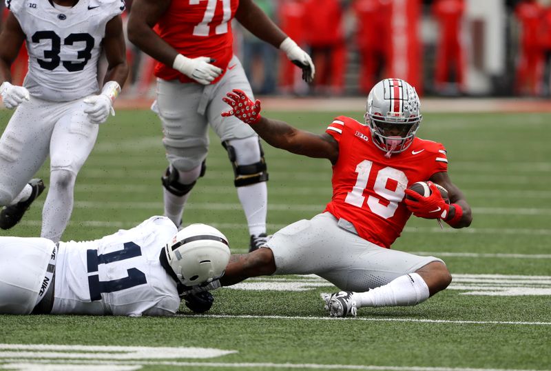 Oct 21, 2023; Columbus, Ohio, USA; Penn State Nittany Lions linebacker Abdul Carter (11) tackles  Ohio State Buckeyes running back Chip Trayanum (19) during the third quarter at Ohio Stadium. Mandatory Credit: Joseph Maiorana-USA TODAY Sports