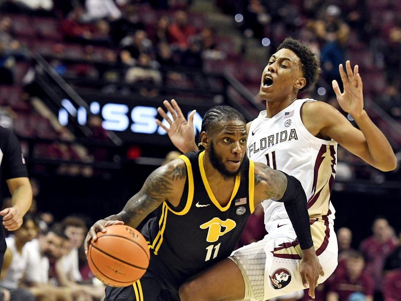 Feb 11, 2023; Tallahassee, Florida, USA; Florida State Seminoles Baba Miller (11) draws an offensive foul from  Pittsburgh Panthers guard Jamarius Burton (11) during the second half at Donald L. Tucker Center. Mandatory Credit: Melina Myers-USA TODAY Sports