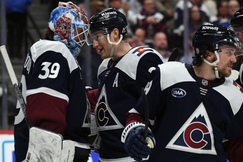 Jan 31, 2025; Denver, Colorado, USA; Colorado Avalanche goaltender Mackenzie Blackwood (39) is congratulated by center Nathan MacKinnon (29) after a shutout win against the St. Louis Blues at Ball Arena. Mandatory Credit: Christopher Hanewinckel-Imagn Images