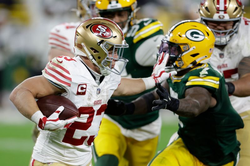 San Francisco 49ers running back Christian McCaffrey (23) stops Green Bay Packers linebacker Quay Walker (7) during the second half of an NFL football game on Sunday, Nov. 24, 2024 in Green Bay, Wis. (AP Photo/Matt Ludtke)