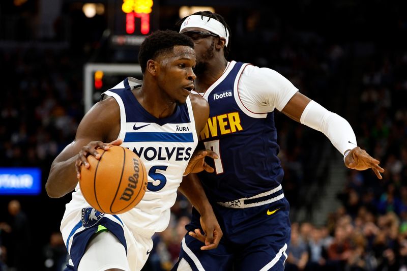 MINNEAPOLIS, MINNESOTA - NOVEMBER 01: Anthony Edwards #5 of the Minnesota Timberwolves drives to the basket while Reggie Jackson #7 of the Denver Nuggets defends in the first quarter at Target Center on November 01, 2023 in Minneapolis, Minnesota. The Timberwolves defeated the Nuggets 110-89. NOTE TO USER: User expressly acknowledges and agrees that, by downloading and or using this photograph, User is consenting to the terms and conditions of the Getty Images License Agreement. (Photo by David Berding/Getty Images)