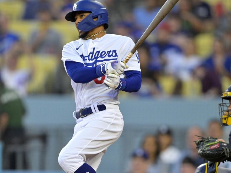 Aug 17, 2023; Los Angeles, California, USA;  Los Angeles Dodgers right fielder Mookie Betts (50) singles in the first inning against the Milwaukee Brewers at Dodger Stadium. Mandatory Credit: Jayne Kamin-Oncea-USA TODAY Sports