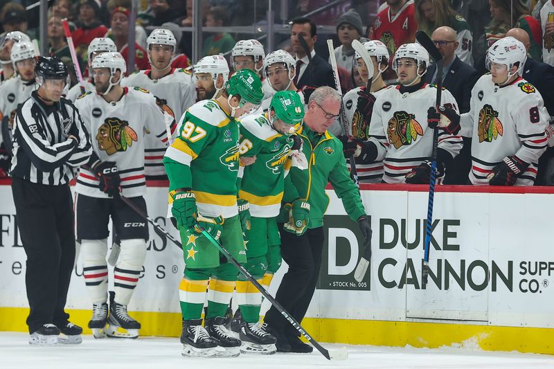 Dec 3, 2023; Saint Paul, Minnesota, USA; Minnesota Wild defenseman Jared Spurgeon (46) is helped off the ice during the first period against the Chicago Blackhawks at Xcel Energy Center. Mandatory Credit: Matt Krohn-USA TODAY Sports