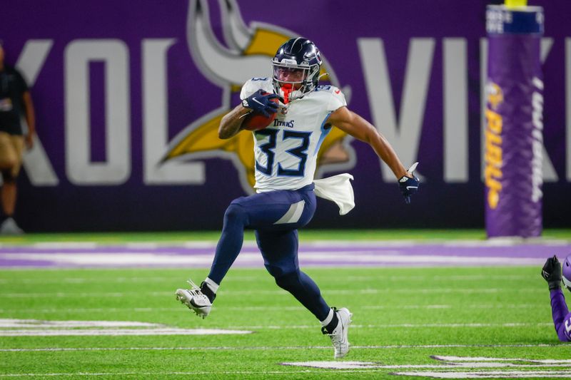 Tennessee Titans defensive back Eric Garror (33) returns a punt against the Minnesota Vikings in the second half of a preseason NFL football game, Saturday, Aug. 19, 2023, in Minneapolis. (AP Photo/Bruce Kluckhohn)