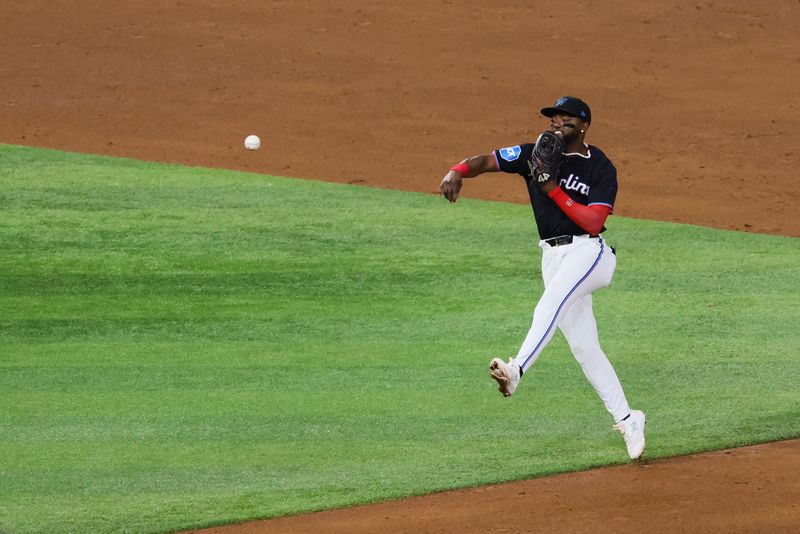 May 10, 2024; Miami, Florida, USA; Miami Marlins second baseman Vidal Brujan (17) throws to first base to retire Philadelphia Phillies first baseman Bryce Harper (not pictured) during the sixth inning at loanDepot Park. Mandatory Credit: Sam Navarro-USA TODAY Sports