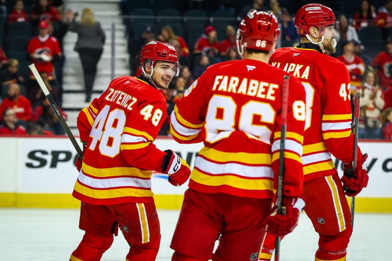 Jan 25, 2026; Calgary, Alberta, CAN; Calgary Flames defenseman Hunter Brzustewicz (48) celebrates his goal with teammates against the Anaheim Ducks during the first period at Scotiabank Saddledome. Mandatory Credit: Sergei Belski-Imagn Images