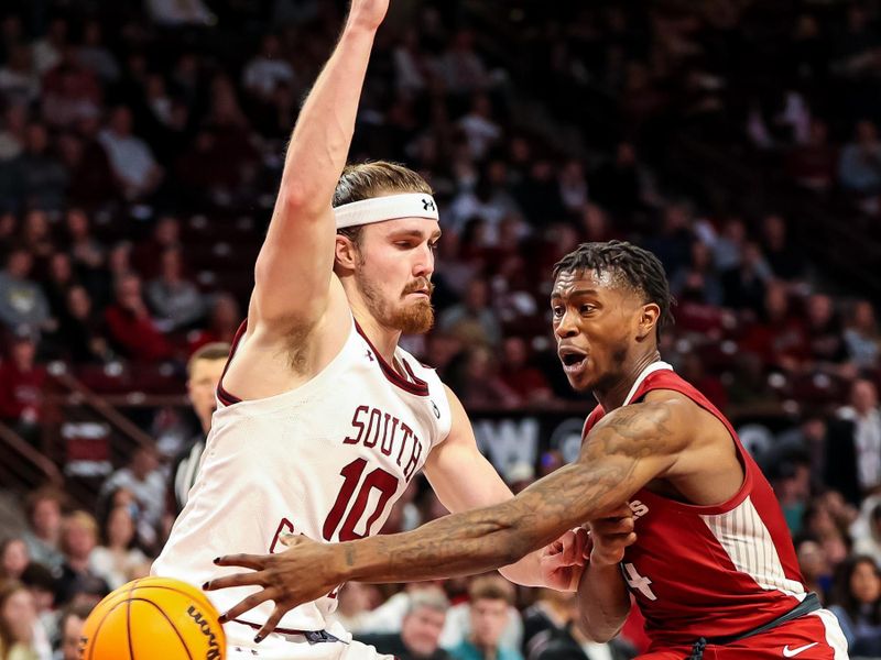 Feb 4, 2023; Columbia, South Carolina, USA; Arkansas Razorbacks guard Davonte Davis (4) passes around South Carolina Gamecocks forward Hayden Brown (10) in the second half at Colonial Life Arena. Mandatory Credit: Jeff Blake-USA TODAY Sports