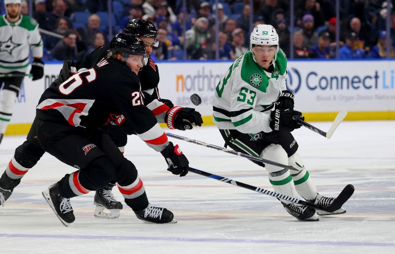 Feb 6, 2024; Buffalo, New York, USA;  Buffalo Sabres defenseman Rasmus Dahlin (26) tries to block the puck as Dallas Stars center Wyatt Johnston (53) shoots it up ice during the third period at KeyBank Center. Mandatory Credit: Timothy T. Ludwig-USA TODAY Sports