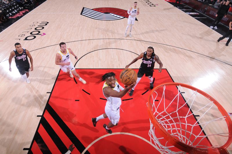 PORTLAND, OR - DECEMBER 6: Isaiah Collier #13 of the Utah Jazz drives to the basket during the game against the Portland Trail Blazers on December 6, 2024 at the Moda Center Arena in Portland, Oregon. NOTE TO USER: User expressly acknowledges and agrees that, by downloading and or using this photograph, user is consenting to the terms and conditions of the Getty Images License Agreement. Mandatory Copyright Notice: Copyright 2024 NBAE (Photo by Cameron Browne/NBAE via Getty Images)