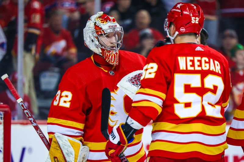 Mar 16, 2024; Calgary, Alberta, CAN; Calgary Flames goaltender Dustin Wolf (32) celebrate win with teammates after defeating Montreal Canadiens at Scotiabank Saddledome. Mandatory Credit: Sergei Belski-USA TODAY Sports