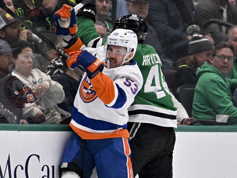 Nov 18, 2025; Dallas, Texas, USA; New York Islanders center Casey Cizikas (53) checks Dallas Stars center Justin Hryckowian (49) during the second period at the American Airlines Center. Mandatory Credit: Jerome Miron-Imagn Images