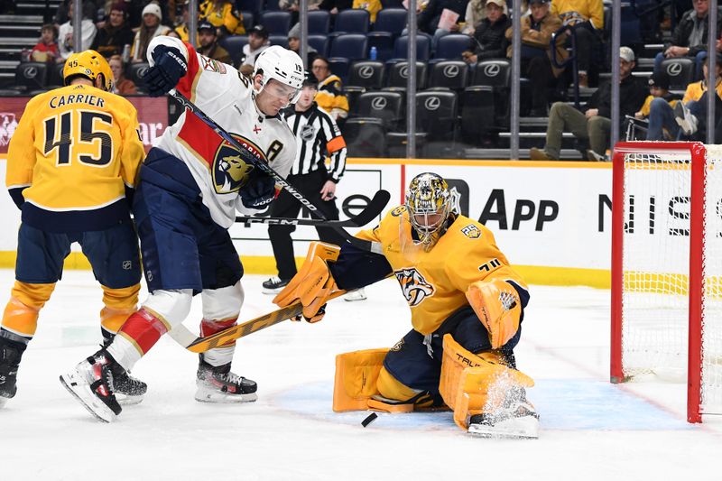 Jan 22, 2024; Nashville, Tennessee, USA; Nashville Predators goaltender Juuse Saros (74) makes a save on a shot by Florida Panthers left wing Matthew Tkachuk (19) during the second period at Bridgestone Arena. Mandatory Credit: Christopher Hanewinckel-USA TODAY Sports