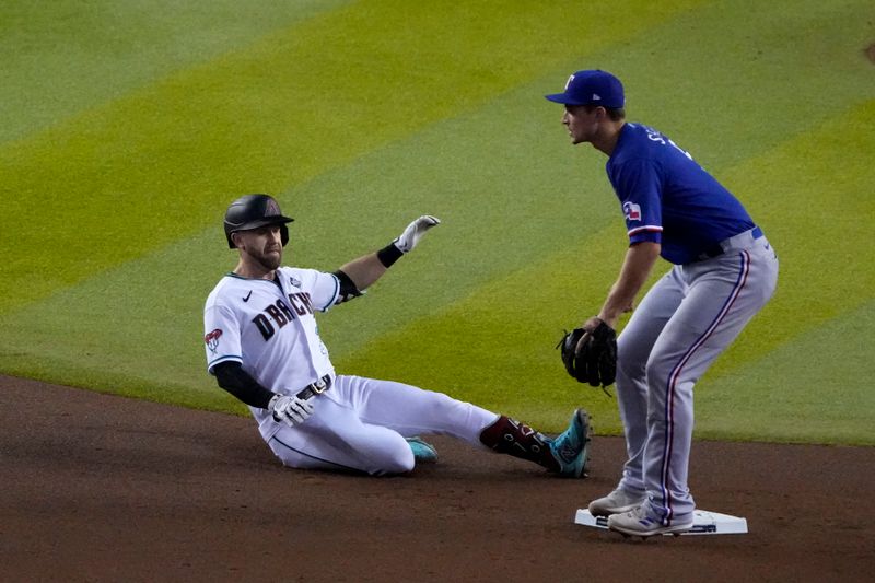 Nov 1, 2023; Phoenix, Arizona, USA; Arizona Diamondbacks third baseman Evan Longoria (3) slides safely into second base against Texas Rangers shortstop Corey Seager (5) during the fourth inning in game five of the 2023 World Series at Chase Field. Mandatory Credit: Rick Scuteri-USA TODAY Sports