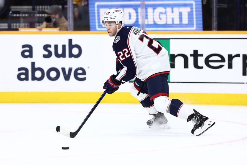 Oct 26, 2024; Nashville, Tennessee, USA; Columbus Blue Jackets defenseman Jordan Harris (22) takes the puck down the ice against the Nashville Predators at Bridgestone Arena. Mandatory Credit: Casey Gower-Imagn Images