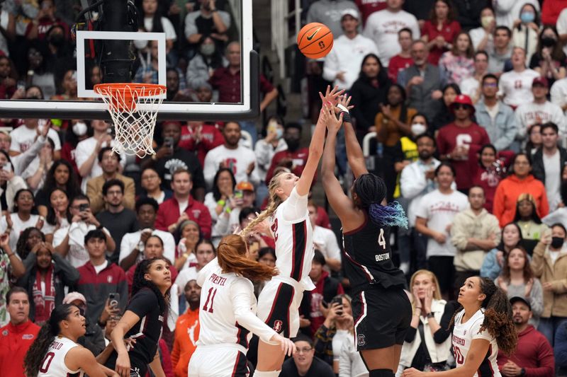 Nov 20, 2022; Stanford, California, USA; South Carolina Gamecocks forward Aliyah Boston (4) scores against Stanford Cardinal forward Cameron Brink (22) during the fourth quarter at Maples Pavilion. Mandatory Credit: Darren Yamashita-USA TODAY Sports