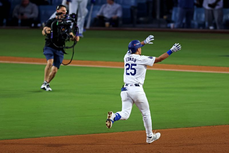 Oct 20, 2024; Los Angeles, California, USA; Los Angeles Dodgers outfielder Tommy Edman (25) celebrates after hitting a two run home run during the third inning against the New York Mets during game six of the NLCS for the 2024 MLB playoffs at Dodger Stadium. Mandatory Credit: Jason Parkhurst-Imagn Images