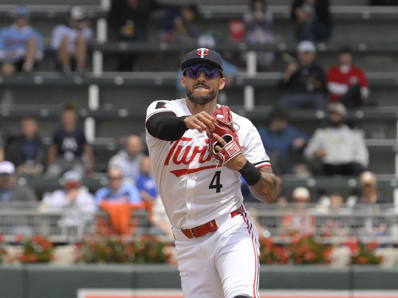 May 27, 2024; Minneapolis, Minnesota, USA; Minnesota Twins infielder Carlos Correa (4) throws to first on the run for a force out against the Kansas City Royals during the second inning at Target Field. Mandatory Credit: Nick Wosika-USA TODAY Sports