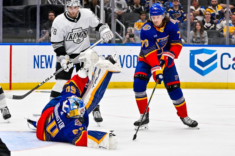 Mar 13, 2024; St. Louis, Missouri, USA;  St. Louis Blues goaltender Jordan Binnington (50) dives with out his stick to make a save against the Los Angeles Kings during the third period at Enterprise Center. Mandatory Credit: Jeff Curry-USA TODAY Sports