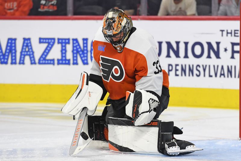 Sep 26, 2024; Philadelphia, Pennsylvania, USA; Philadelphia Flyers goaltender Samuel Ersson (33) makes a save against the New York Islanders during the third period at Wells Fargo Center. Mandatory Credit: Eric Hartline-Imagn Images