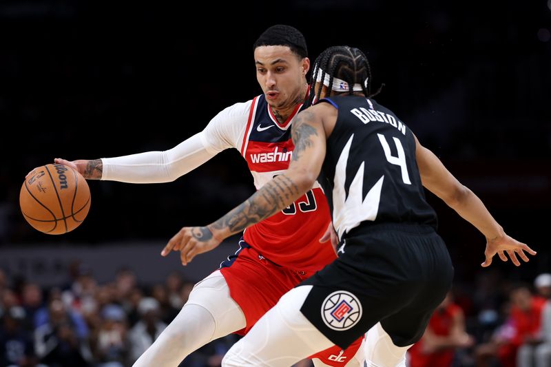 WASHINGTON, DC - JANUARY 31: Kyle Kuzma #33 of the Washington Wizards dribbles in front of Brandon Boston Jr. #4 of the LA Clippers during first half at Capital One Arena on January 31, 2024 in Washington, DC. NOTE TO USER: User expressly acknowledges and agrees that, by downloading and or using this photograph, User is consenting to the terms and conditions of the Getty Images License Agreement. (Photo by Patrick Smith/Getty Images)