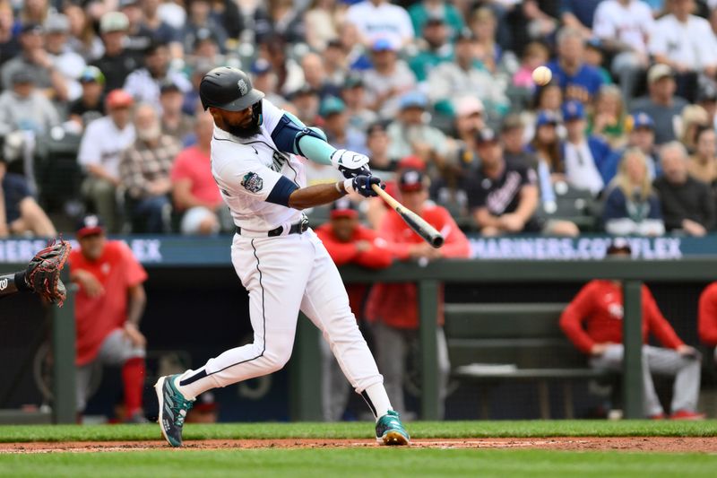 Jun 27, 2023; Seattle, Washington, USA; Seattle Mariners right fielder Teoscar Hernandez (35) hits a 2-run home run against the Washington Nationals during the first inning at T-Mobile Park. Mandatory Credit: Steven Bisig-USA TODAY Sports