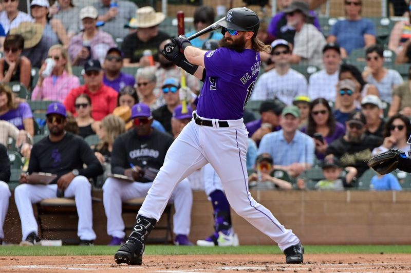 Mar 12, 2024; Salt River Pima-Maricopa, Arizona, USA;   Colorado Rockies designated hitter Charlie Blackmon (19) singles in the first inning against the Kansas City Royals during a spring training game at Salt River Fields at Talking Stick. Mandatory Credit: Matt Kartozian-USA TODAY Sports