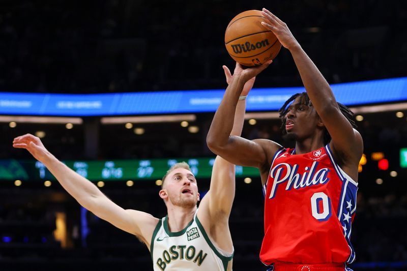 BOSTON, MA - FEBRUARY 27:  Tyrese Maxey #0 of the Philadelphia 76ers shoots over Sam Hauser #30 of the Boston Celtics in the first quarter of a game at TD Garden on February 27, 2024 in Boston, Massachusetts. NOTE TO USER: User expressly acknowledges and agrees that, by downloading and or using this photograph, User is consenting to the terms and conditions of the Getty Images License Agreement. (Photo by Adam Glanzman/Getty Images)