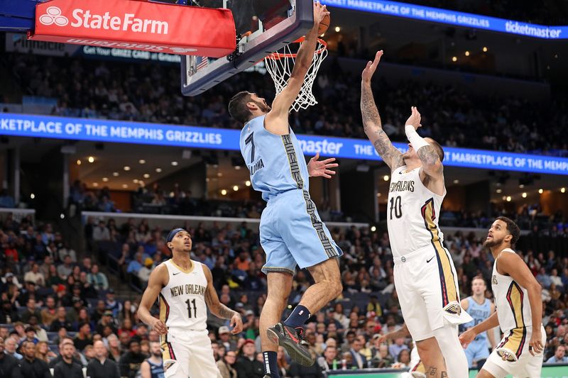 MEMPHIS, TENNESSEE - NOVEMBER 29: Santi Aldama #7 of the Memphis Grizzlies goes to the basket against Daniel Theis #10 of the New Orleans Pelicans during the first half of an Emirates NBA Cup game at FedExForum on November 29, 2024 in Memphis, Tennessee. NOTE TO USER: User expressly acknowledges and agrees that, by downloading and or using this photograph, User is consenting to the terms and conditions of the Getty Images License Agreement. (Photo by Justin Ford/Getty Images)