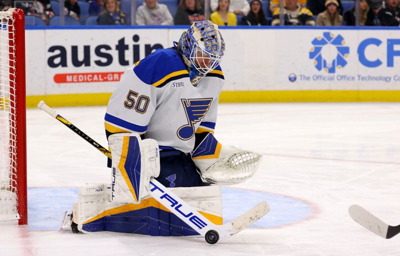 Nov 14, 2024; Buffalo, New York, USA;  St. Louis Blues goaltender Jordan Binnington (50) makes a stick save during the second period against the Buffalo Sabres at KeyBank Center. Mandatory Credit: Timothy T. Ludwig-Imagn Images