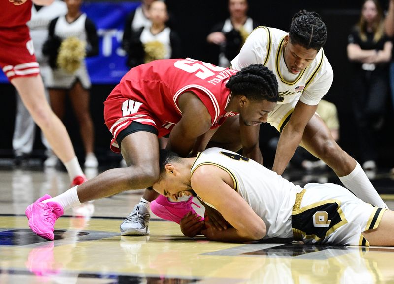 Feb 15, 2025; West Lafayette, Indiana, USA; Wisconsin Badgers guard John Blackwell (25) and Purdue Boilermakers guard Gicarri Harris (24) go after a loose ball with forward Trey Kaufman-Renn (4) during the second half at Mackey Arena. Mandatory Credit: Marc Lebryk-Imagn Images