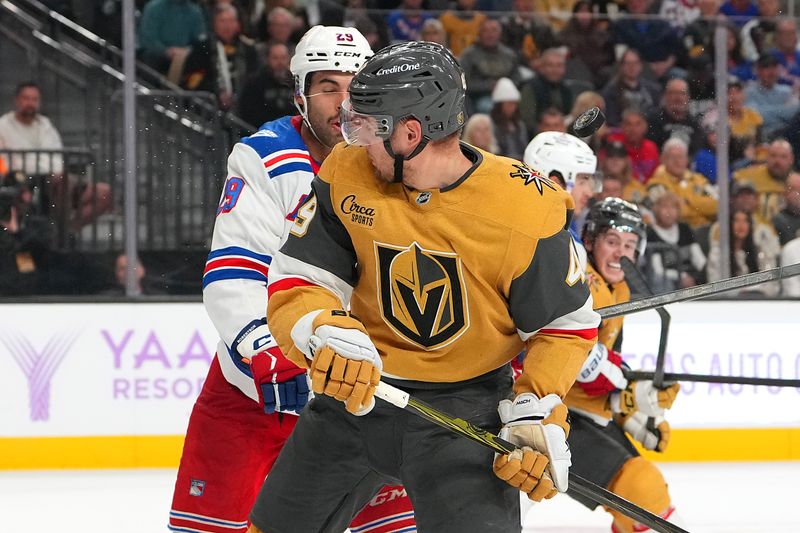 Nov 18, 2025; Las Vegas, Nevada, USA; A shot deflects off the back of Vegas Golden Knights left wing Ivan Barbashev (49) as New York Rangers defenseman Matthew Robertson (29) looks to apply a check during the third period at T-Mobile Arena. Mandatory Credit: Stephen R. Sylvanie-Imagn Images