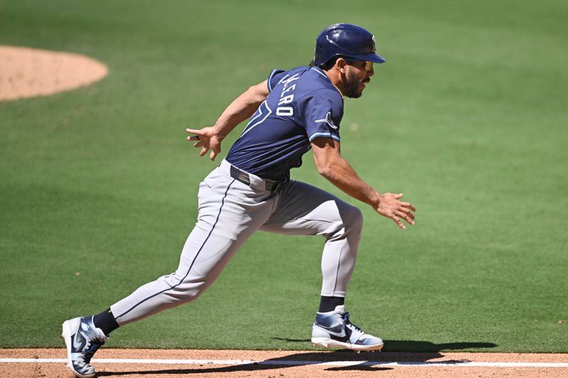 Apr 27, 2025; San Diego, California, USA; Tampa Bay Rays outfielder Jose Caballero (77) runs as he tries to score during the seventh inning against the San Diego Padres at Petco Park. Mandatory Credit: Denis Poroy-Imagn Images